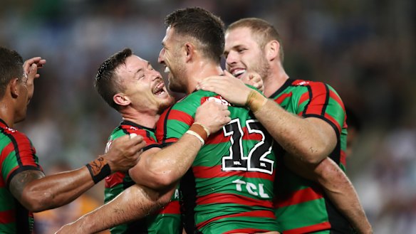 Destructive force: The Bunnies gather around Sam Burgess after he scored against Brisbane.
