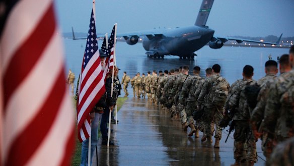 Paratroopers from the 1st Brigade Combat Team prepare prepare equipment and load aircraft at Fort Bragg back in January.