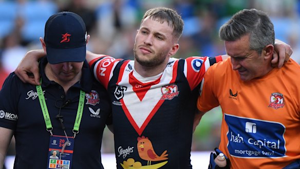 Sam Walker is helped off the field after suffering a ruptured ACL against Canberra.