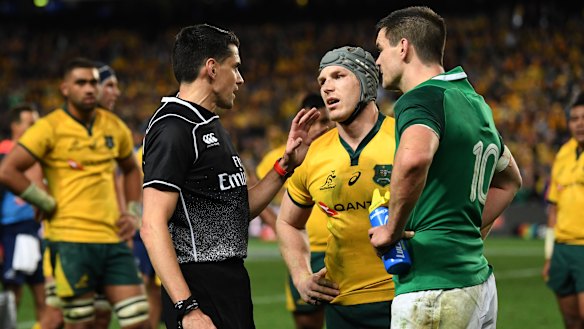 David Pocock waiting to speak with match referee Pascal Gauzre.