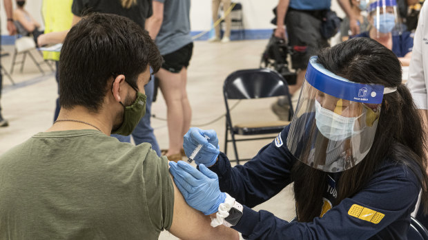 Kent State University student Jarrett Wooes gets his Johnson & Johnson shot prior to its suspension in the US.