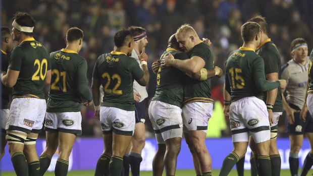 Just: South African players celebrate their hard-fought victory over Scotland.