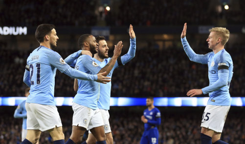 Manchester City players celebrate a Raheem Sterling goal against Chelsea.