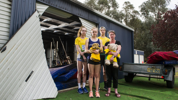 Woden athletics club users Grace Brennan, Caitlin Hanna, Erek Lukowski and Woden Thunder Little Athletics Club Secretary Mel Harding are disappointed to see a shed containing sports equipment at the Woden Athletics Park destroyed due to arson.