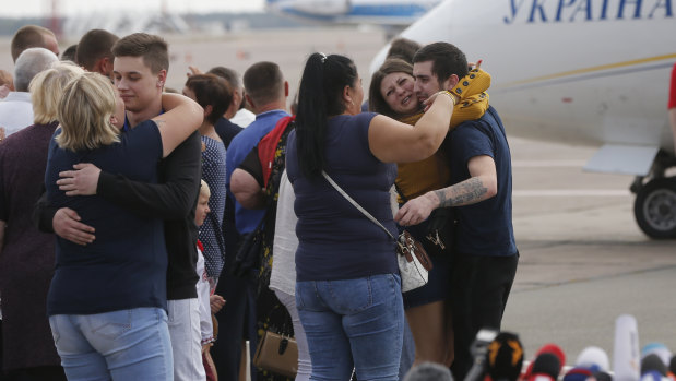 Relatives of Ukrainian prisoners freed by Russia greet them upon their arrival un Ukraine.