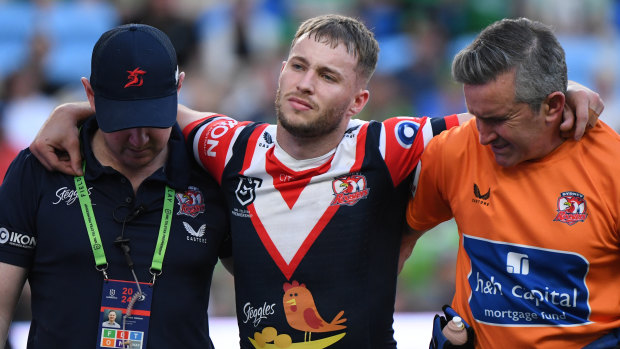 Sam Walker is helped off the field after suffering a ruptured ACL against Canberra.