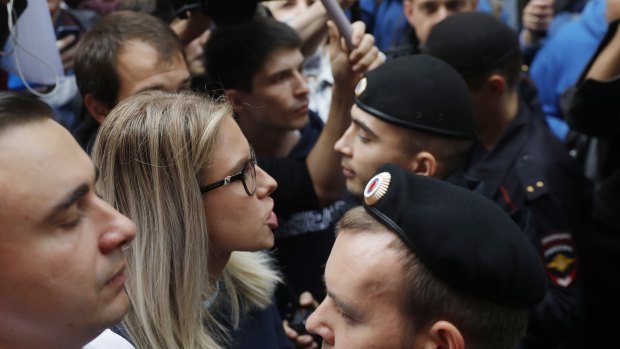 Russian opposition candidate and lawyer at the Foundation for Fighting Corruption Lyubov Sobol, centre, stands in front of police during a protest in Moscow.