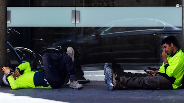 Workers get some respite in the shade in Sydney’s CBD on Thursday.