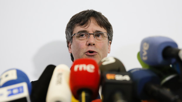 Former Catalan leader Carles Puigdemont attends a news conference in Berlin, Germany, on Tuesday. His pro-independence colleagues are on trial.