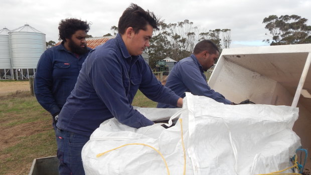 Rangers Braydon Saunders, Sean Bell and Rowen Pickett loading clay balls for a trial aerial seeding.