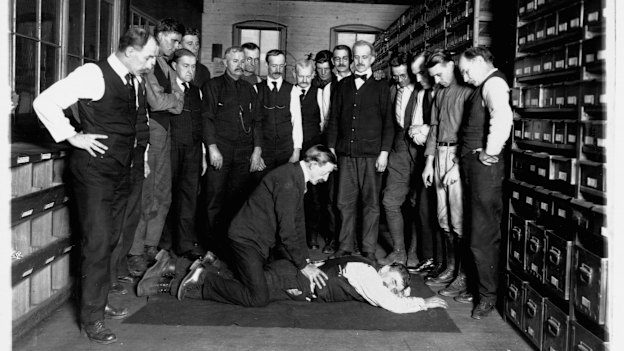 A demonstration of artificial respiration to workers at the Chesapeake & Potomac Telephone Company in Washington DC in 1922. 