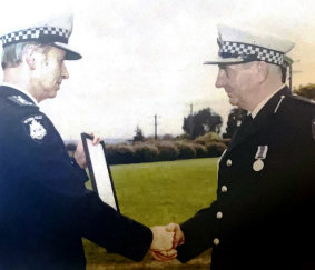 Daryl Payne receives an award from  then chief commissioner Mick Miller.