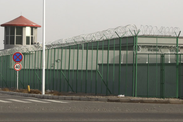 A guard tower and barbed wire fences are seen around a facility in the Kunshan Industrial Park in Artux in western China's Xinjiang region. People in touch with state employees in China say the government in the far west region of Xinjiang is destroying documents and taking other steps to tighten control on information. 