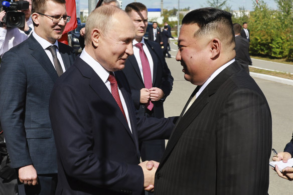 Russian President Vladimir Putin greets and North Korea’s leader Kim Jong-un.