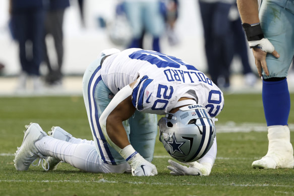 Dallas Cowboys player Tony Pollard on the ground following a hip-drop tackle that tore his ligaments and fractured his fibula.