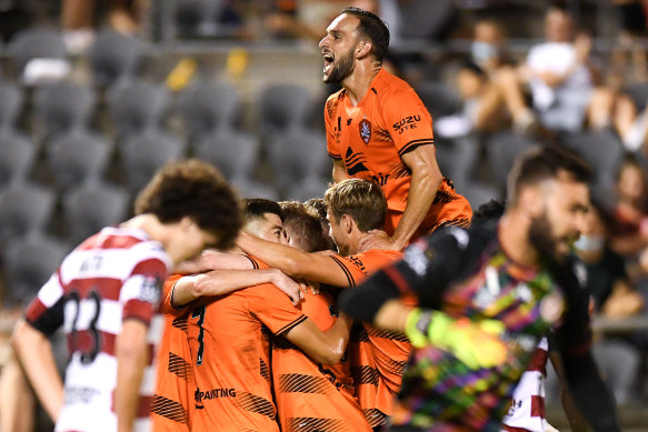 Jack Hingert celebrates one of Nikola Mileusnic’s goals as a dejected Mark Natta watches on.