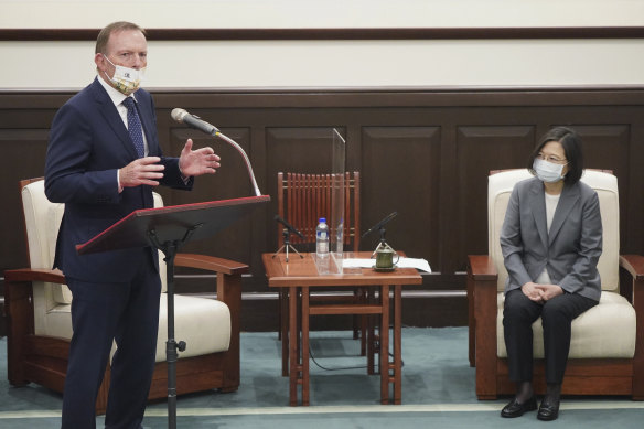 Taiwanese President Tsai Ing-wen watches former Australian prime minister Tony Abbott at the Presidential Office in Taipei. 