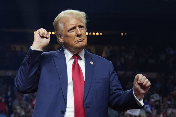 Republican presidential nominee former President Donald Trump dances at a campaign rally at the Desert Diamond Arena in Arizona a day after Kamala Harris’ nomination.