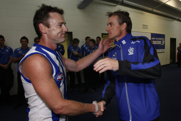 Adam Simpson, left, is congratulated by Dani Laidley, pictured in 2009 during her coaching days, following a win against Essendon. 