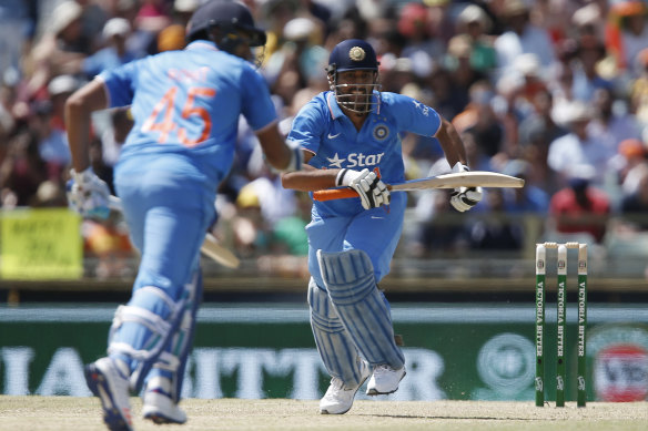 Dhoni runs between the wickets in an ODI against Australia in 2016.