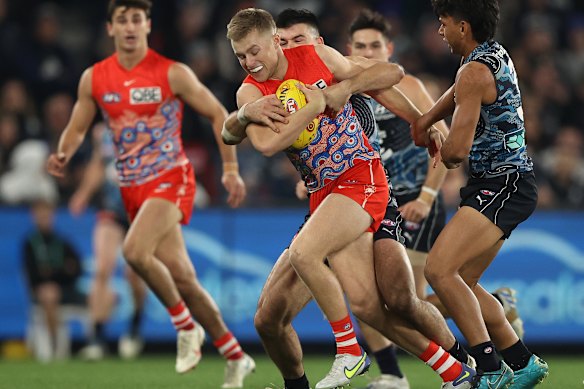 Braeden Campbell of the Swans is challenged by Matthew Kennedy.