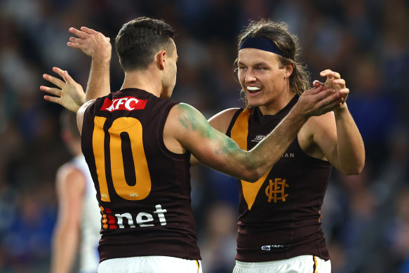 Hawthorn celebrate a goal.