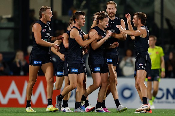 Carlton players celebrate a Sam Walsh goal.
