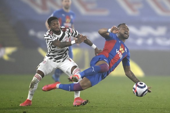 Manchester United’s Fred (left) challenges Crystal Palace’s Jordan Ayew.