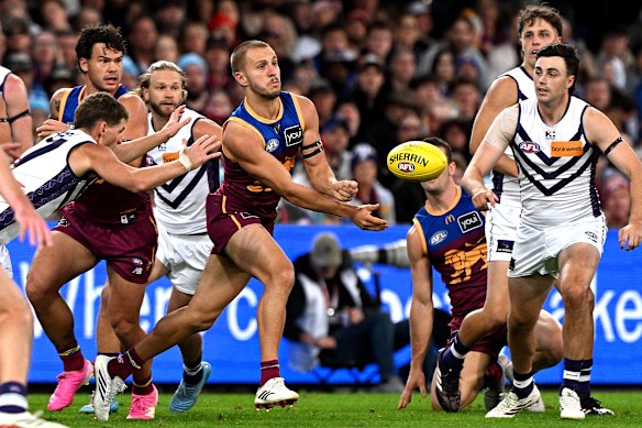 Kai Lohmann of the Lions gets a handball away.