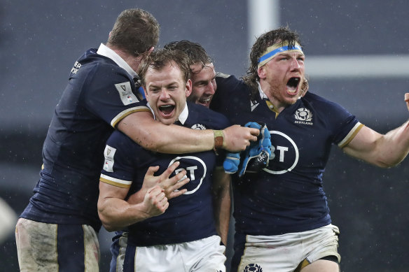 Scotland’s Hamish Watson, right, and teammates celebrate at the end of the Six Nations rugby union international between England and Scotland at Twickenham stadium in London, Saturday, Feb. 6, 2021. 