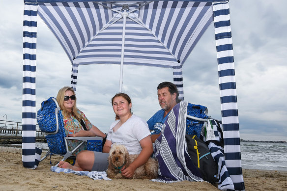 Annette Maloney – pictured with husband Peter, daughter Tess and their dog – says the family has been staying at the beach for longer since getting a cabana.