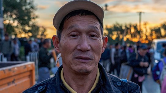 Xiao Zhiquan, 59, waits by the road in eastern Beijing each day hoping to pick up work.