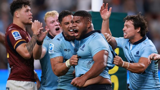 Sifa Amone is mobbed by teammates after scoring the match-winning try for NSW in round one.
