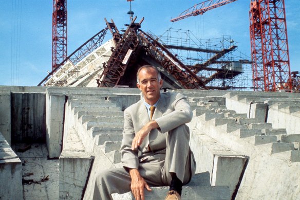 Utzon in front of the partially constructed Opera House in 1965.