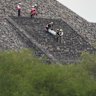 Forensic workers carry the body of a victim down a pyramid after authorities said a gunman opened fire, in Teotihuacan, Mexico, on Monday.