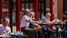 Drinkers outside  a pub in London’s Soho.