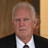 Former AFL umpire coach Frank Kalayzich (right) departs a Fair Work Commission hearing