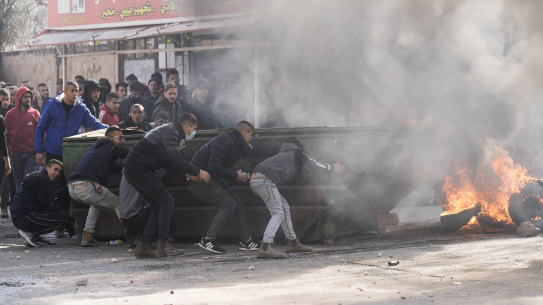 Palestinians clash with Israeli forces following an army raid in the West Bank city of Jenin on Thursday.