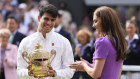 Carlos Alcaraz smiles after receiving his trophy from the Princess of Wales.