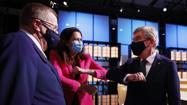 The president of the International Olympic Committee, Thomas Bach, right, bumps elbows with Premier Annastacia Palaszczuk and John Coates. 