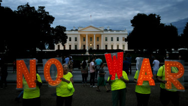 Protesters make their demands known outside the White House on Thursday.