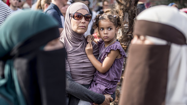 People demonstrate in Copenhagen, Denmark as the new ban on garments covering the face is implemented. 