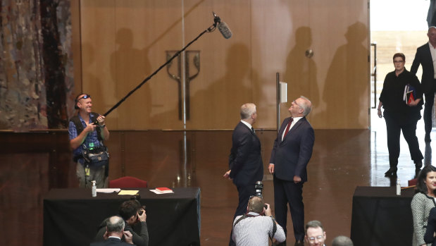 These are not the days for careless words ... Deputy Prime Minister Michael McCormack and Prime Minister Scott Morrison clam up after spotting the boom microphone above them.