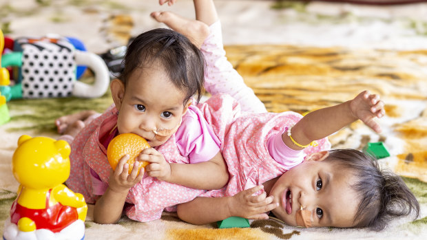 Nima (left) and Dawa play at the country retreat they have called their home for the past month. 