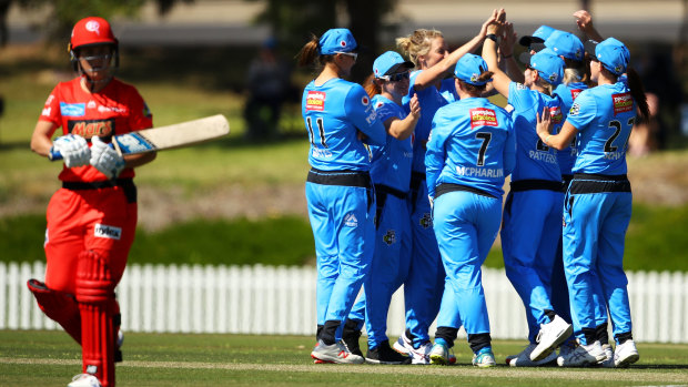 Early breakthrough: Strikers' all-rounder Sophie Devine celebrates with teammates after taking the wicket of Renegades opener Sophie Molineux.