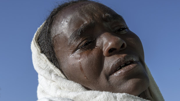 A Tigrayan woman who fled the conflict in Ethiopia's Tigray region, weeps after Sunday Mass ends at a church, near Umm Rakouba refugee camp in Qadarif, eastern Sudan.