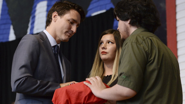 Indigenous youth present the final report to Canadian Prime Minister Justin Trudeau.