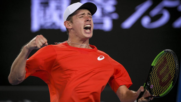 Alex de Minaur celebrates after winning a five-set epic to advance to the third round.