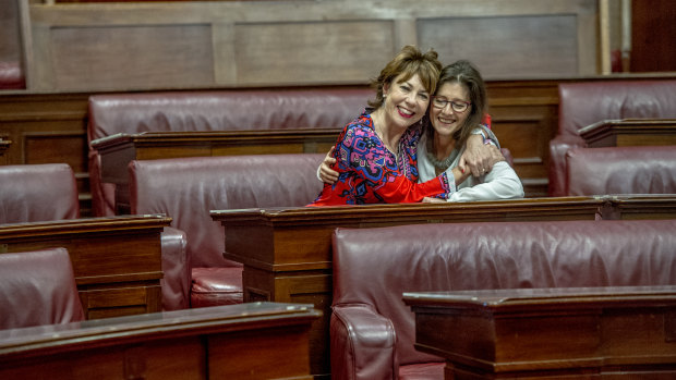 Kathy Lette sits in the seat once occupied by the first woman elected to the Senate, Dorothy Tangney. Pictured with her is Museum of Australian Democracy director Daryl  Karp.