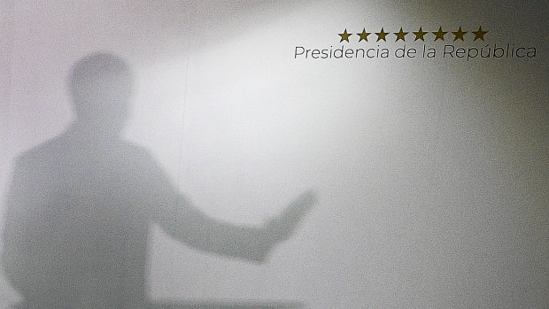 The shadow of Venezuela's Opposition Leader Juan Guaido is projected on a wall during a press conference at his private office in Caracas on Sunday.
